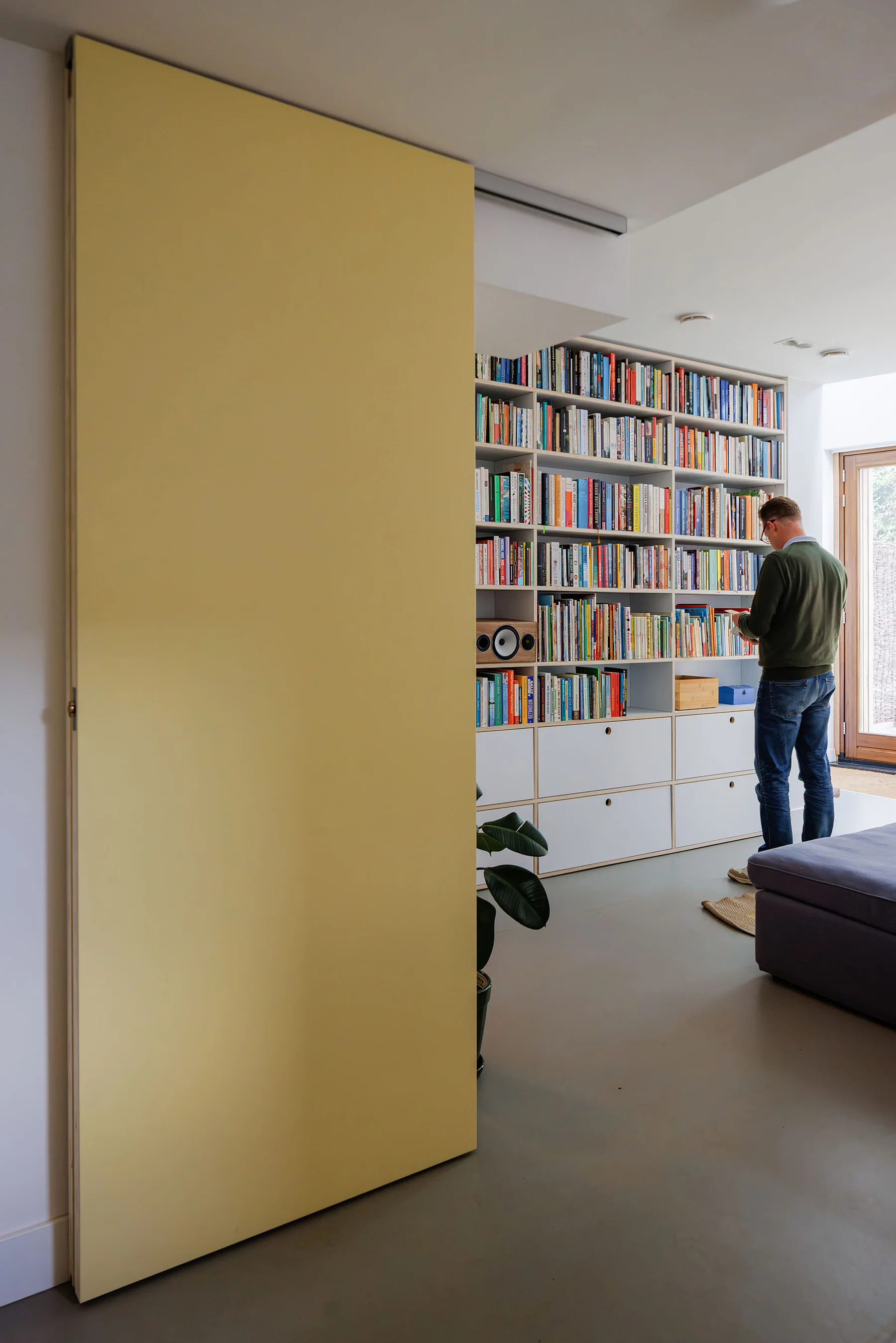 Pale yellow folding door opening to the library