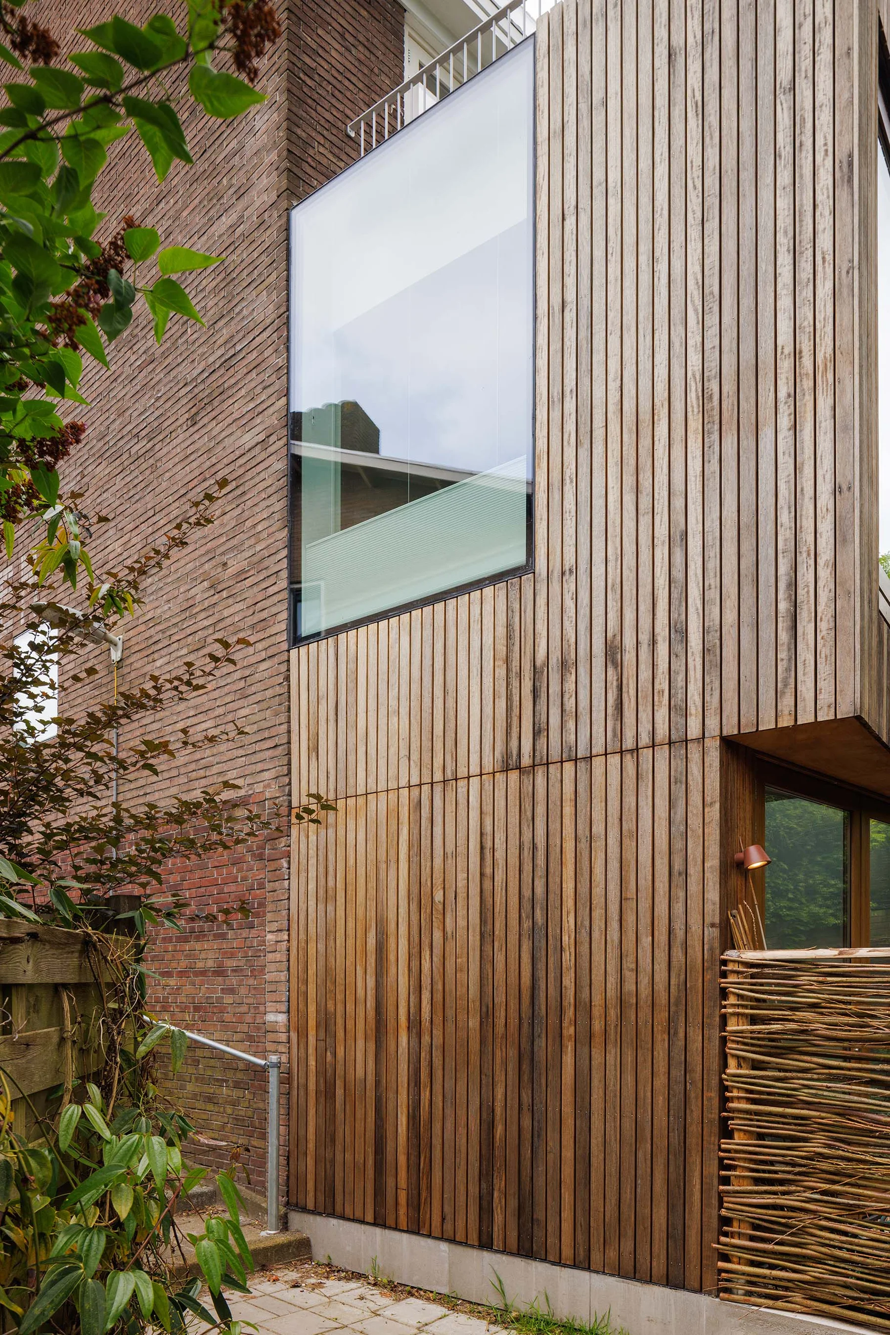Flush glazing set into vertical timber cladding
